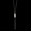 Gold lariat drop necklace with an oval white gemstone pendant against a black background.