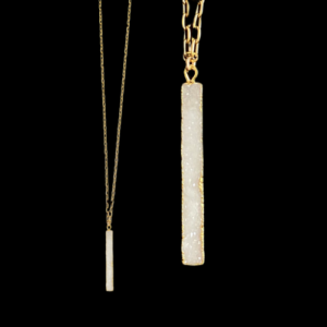 white stone necklace on gold chain