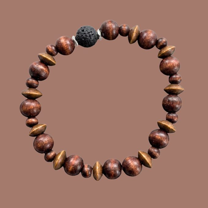 Beaded aromatherapy bracelet with brown wooden beads and a black lava rock centered on a solid brown background.