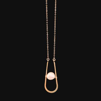 A minimalist necklace with a fine gold chain suspending a modern U-shaped wire pendant that cradles a single floating pinkish-white baroque pearl, isolated on a stark black background.