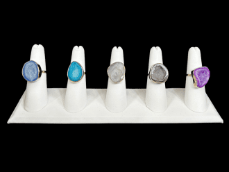 Colorful geode rings featuring vibrant gemstones in various shades of dark blue, turquoise, gray, brown and purple. These unique gemstone rings showcase natural geode crystals, perfect for bohemian and statement jewelry lovers. Ideal for adding a pop of color and natural beauty to any outfit