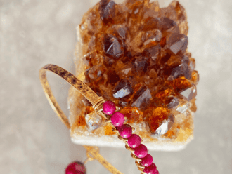 Pink gemstone bangle with citrine gemstone.