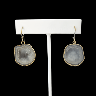 Handcrafted druzy earrings with kidney earwires, featuring natural gray geode slices with a gold-plated edge.