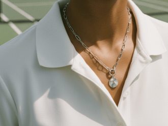 Silver pickleball necklace with pickleball paddle charm.