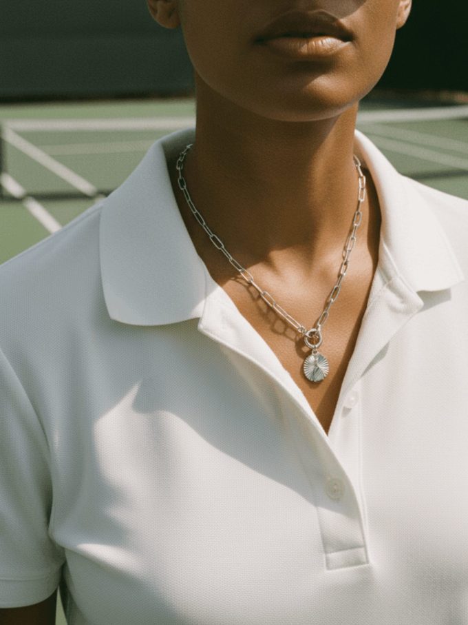 Silver pickleball necklace with pickleball paddle charm.