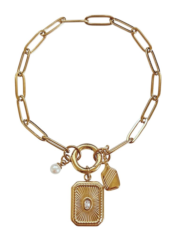 Luxury pickleball charm bracelet with link chain, paddle charm, pearl accent, and rectangular pendant in gold.