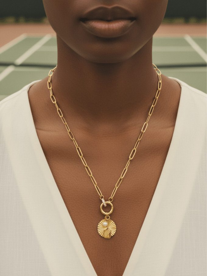 Gold pickleball and padel necklace with caribiner clasp.