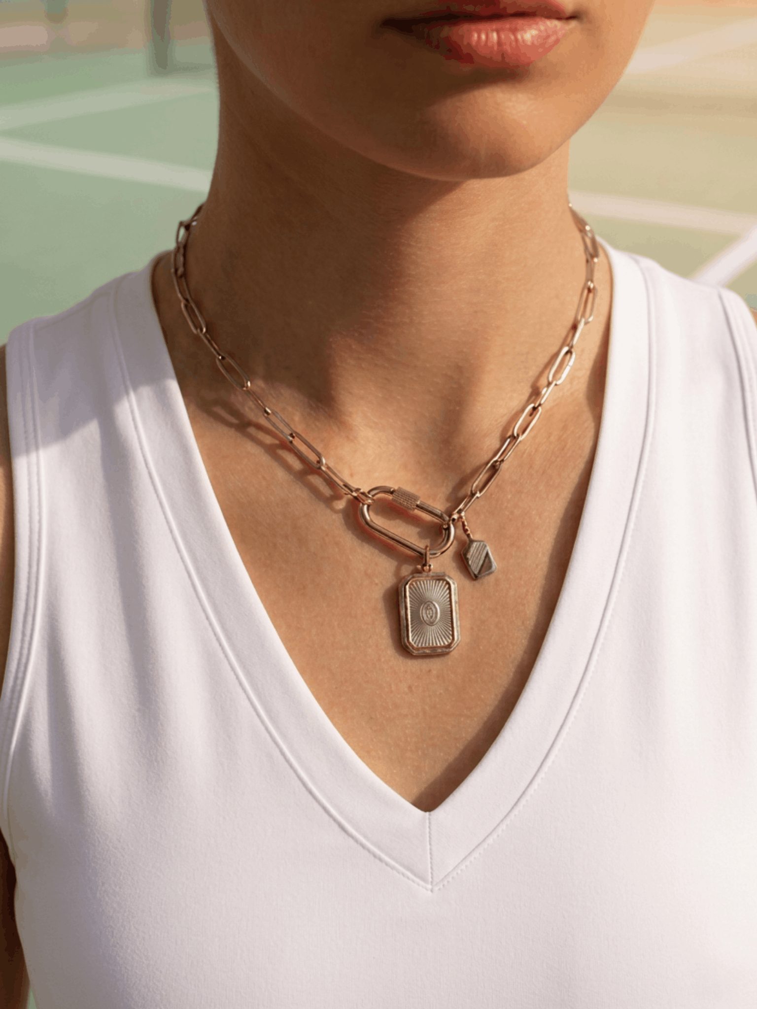 Silver picklenball necklace with carabiner charm clasp.