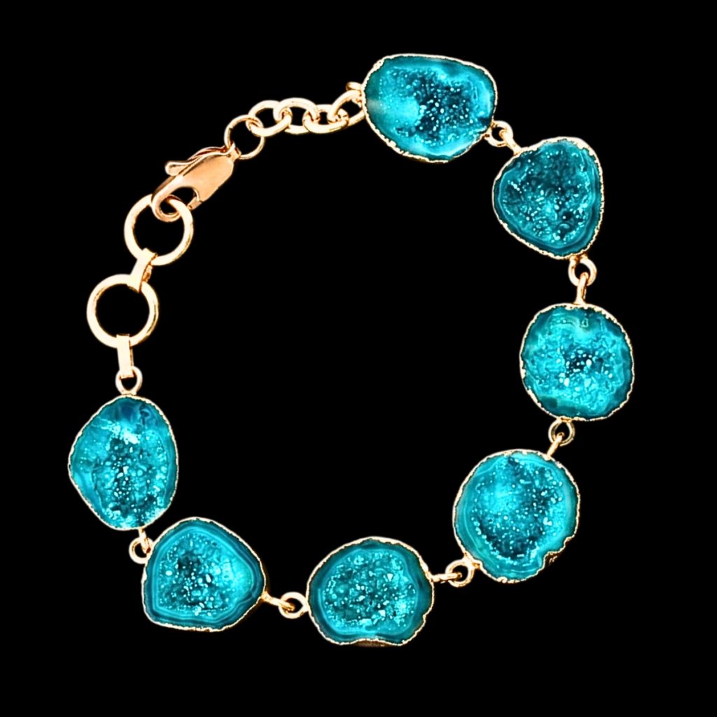 Handmade gold-plated link bracelet featuring irregular turquoise blue geode agate slices with glittering crystalline druzy centers.