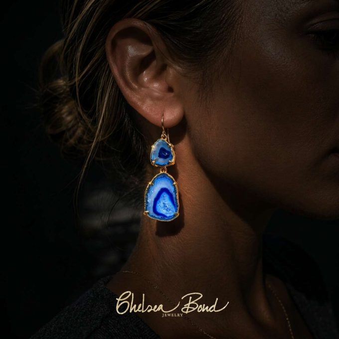 Chelsea Bond Jewelry blue agate geode druzy slice dangle earrings with gold plating worn by a model.