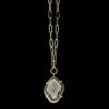 Gold druzy geode pendant necklace by Chelsea Bond Jewelry, featuring an organic-shaped gemstone set in a gold prong setting on a textured gold chain against a black background.