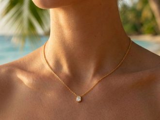 Woman wearing a waterproof gold necklace with cubic zirconia stone.
