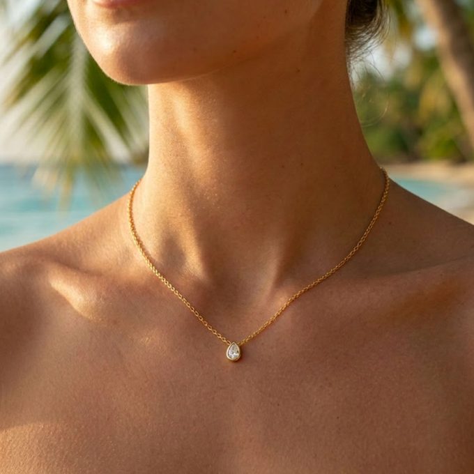 Woman wearing a waterproof gold necklace with cubic zirconia stone.
