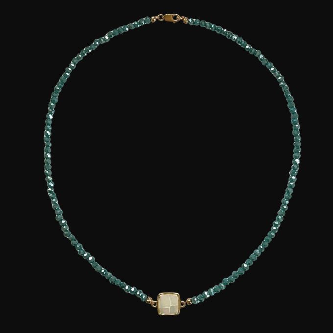 Faceted teal green glass bead strand necklace with a square mother of pearl central connector charm and gold clasp.
