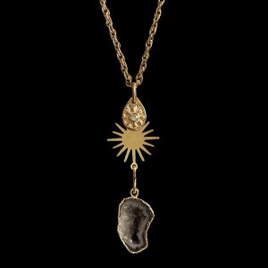 Gold link chain necklace featuring three tiered charms: a teardrop starburst disk, a flat gold sunburst, and and electroplated druzy slice, curated for luxury spa jewelry lines.