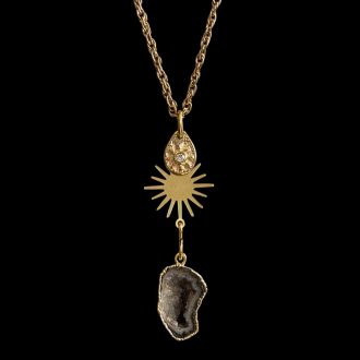 Gold link chain necklace featuring three tiered charms: a teardrop starburst disk, a flat gold sunburst, and and electroplated druzy slice, curated for luxury spa jewelry lines.